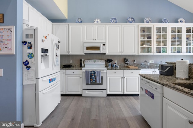 kitchen with lofted ceiling, white cabinetry, light wood-type flooring, and white appliances