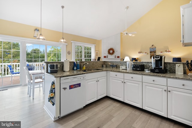 kitchen featuring white cabinetry, light hardwood / wood-style flooring, dishwasher, and dark stone counters