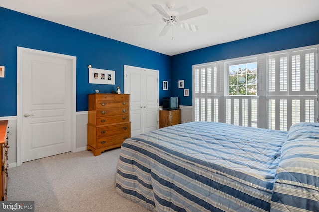 carpeted bedroom featuring a closet and ceiling fan