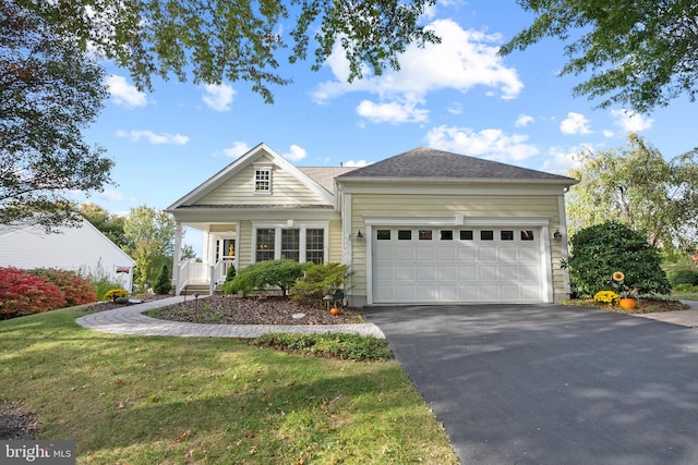 view of front facade with a porch, a front lawn, and a garage