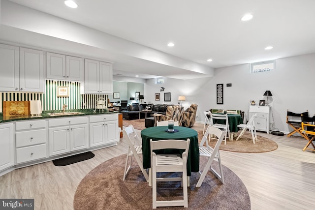 dining area with light hardwood / wood-style floors and sink