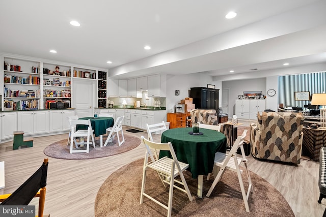 dining space featuring light hardwood / wood-style flooring and built in features