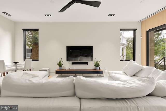 living room with ceiling fan and a healthy amount of sunlight