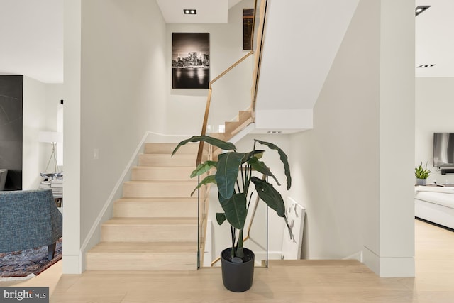 stairs with wood-type flooring