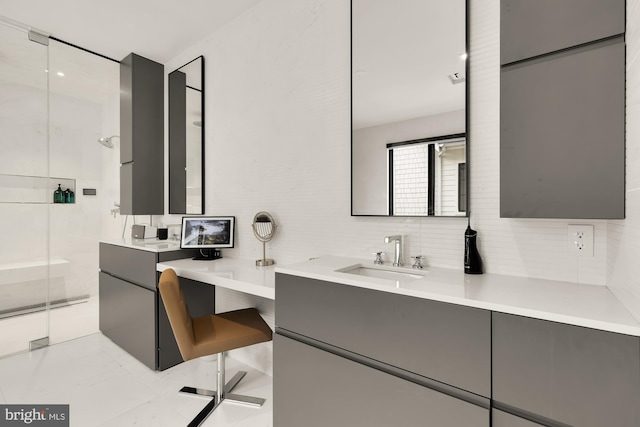 bathroom with vanity, walk in shower, and decorative backsplash