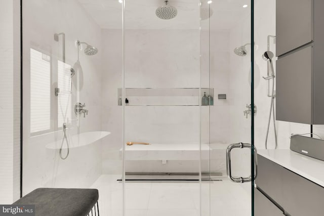 bathroom with a shower with shower door and a healthy amount of sunlight