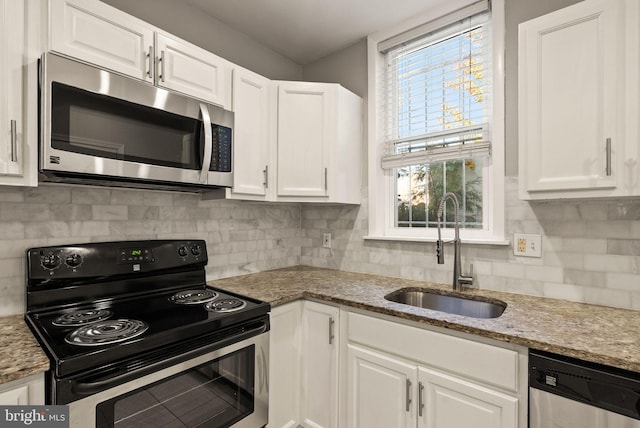 kitchen with white cabinetry, stainless steel appliances, and a wealth of natural light