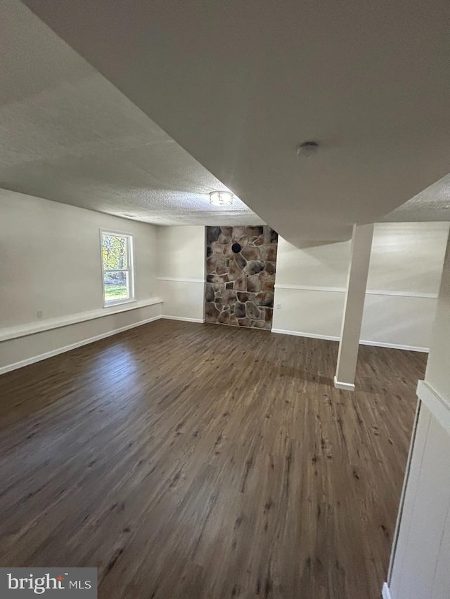 bonus room featuring a textured ceiling and dark hardwood / wood-style floors