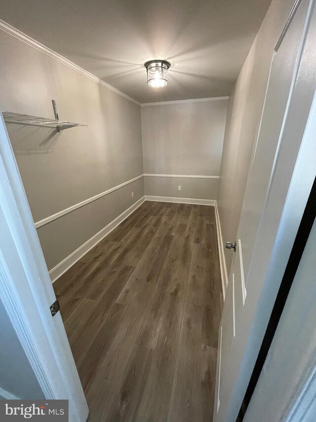 spare room with crown molding and dark hardwood / wood-style flooring