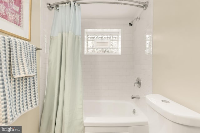 bathroom featuring shower / bath combo and toilet