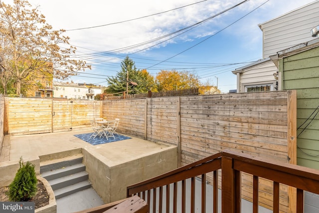 wooden deck with a patio