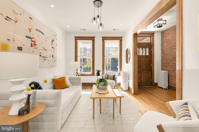 sitting room with light hardwood / wood-style floors and radiator