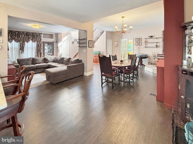 living room featuring dark wood-type flooring and an inviting chandelier