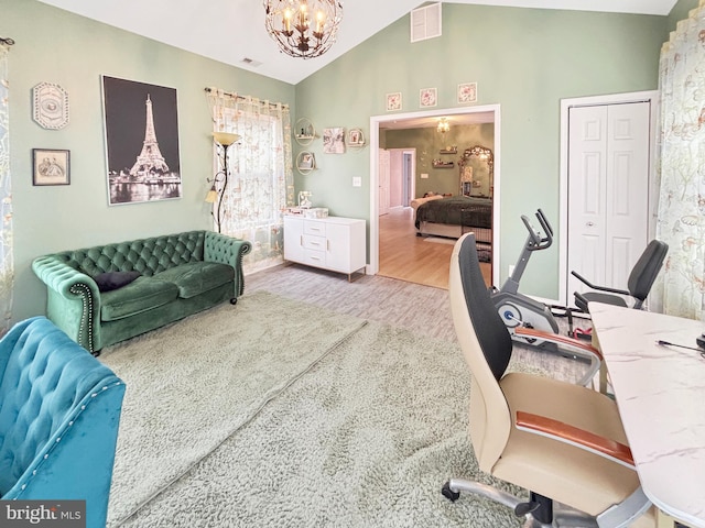 office with lofted ceiling, wood-type flooring, and an inviting chandelier