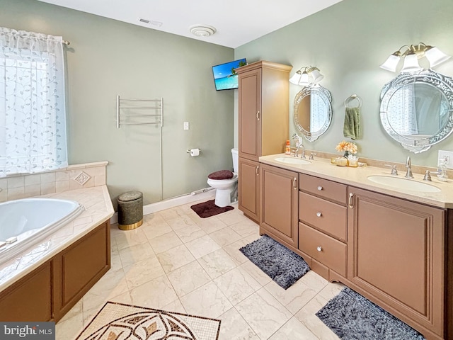 bathroom featuring vanity, a bathtub, and toilet