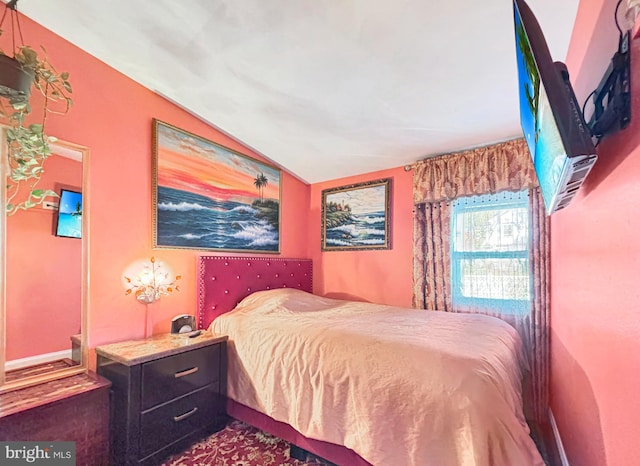 carpeted bedroom with vaulted ceiling