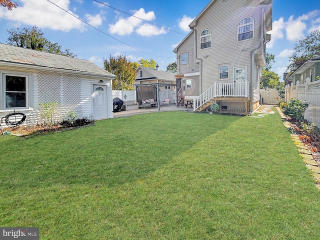 back of house featuring a yard and a patio