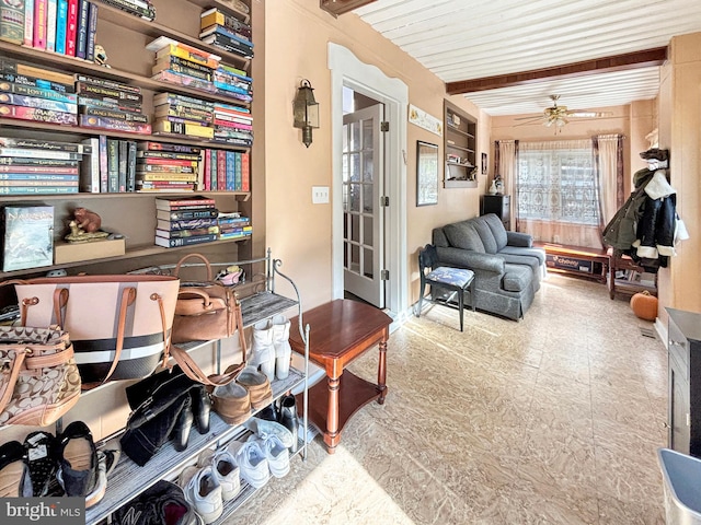 sitting room featuring beam ceiling and ceiling fan