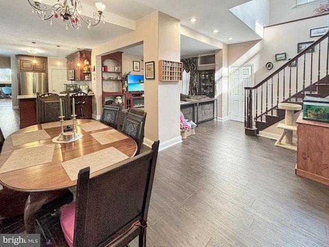 dining room with an inviting chandelier and dark hardwood / wood-style floors