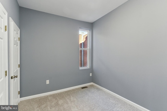 unfurnished room with light colored carpet