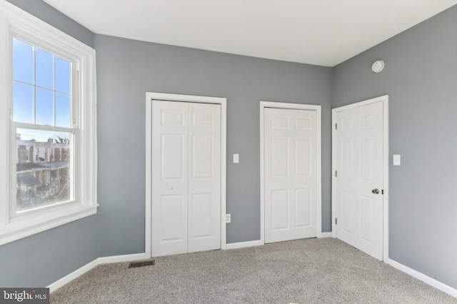 unfurnished bedroom featuring light colored carpet