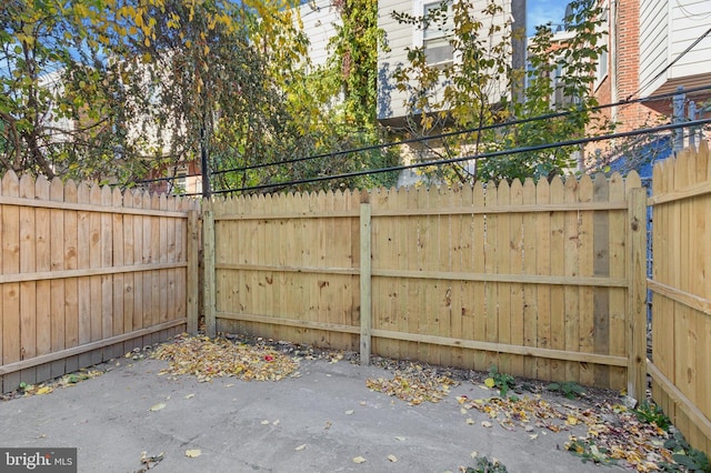 view of gate with a patio