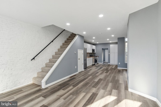 unfurnished living room featuring hardwood / wood-style floors