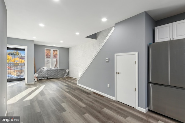 interior space with stainless steel fridge and wood-type flooring