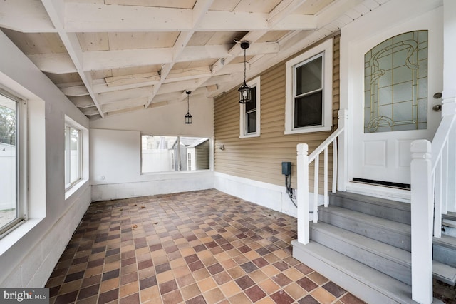 unfurnished sunroom featuring wood ceiling and vaulted ceiling with beams