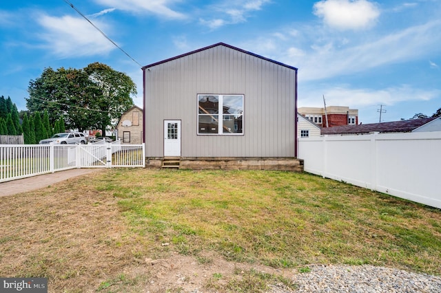 rear view of property featuring a yard