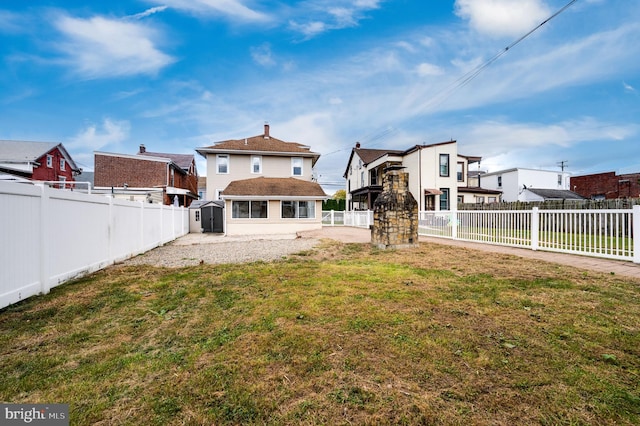 rear view of property with a lawn