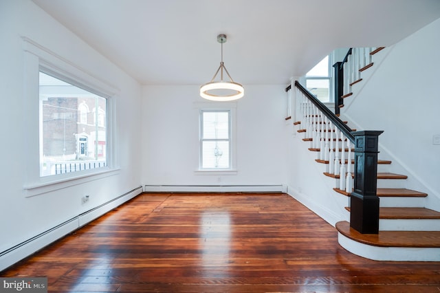 interior space featuring a baseboard heating unit and dark hardwood / wood-style flooring