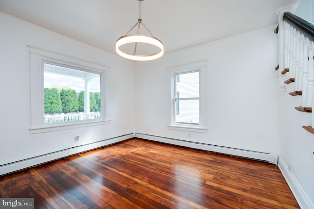 empty room featuring a baseboard radiator and dark hardwood / wood-style flooring