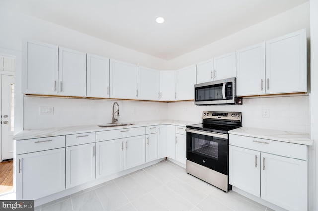 kitchen featuring white cabinets, stainless steel appliances, and sink