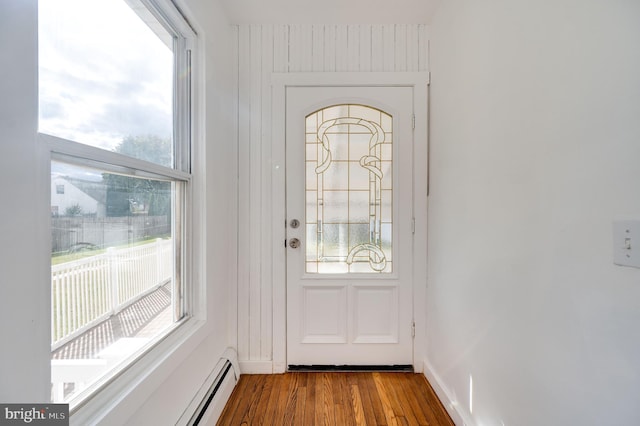 entryway featuring hardwood / wood-style floors and a baseboard heating unit