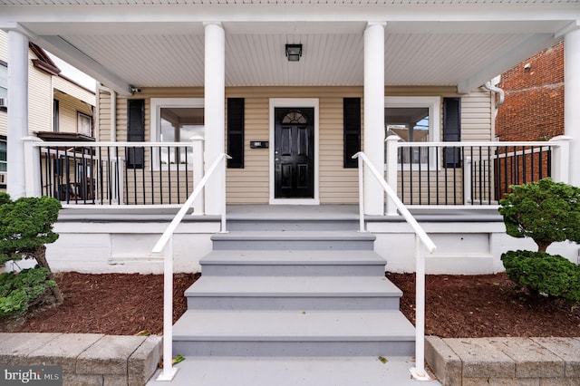 view of exterior entry featuring a porch