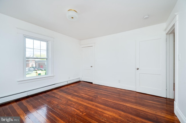 unfurnished bedroom with a baseboard radiator and dark hardwood / wood-style flooring