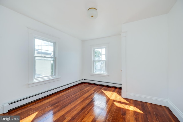 spare room with hardwood / wood-style flooring and a baseboard radiator