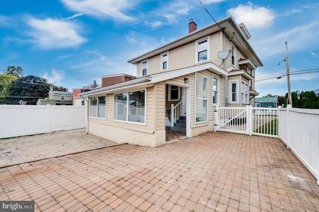 back of property featuring a patio