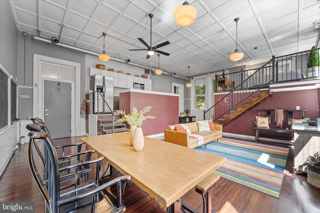 dining space with ceiling fan and dark hardwood / wood-style floors