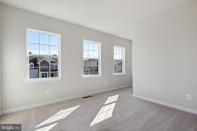 empty room with light colored carpet