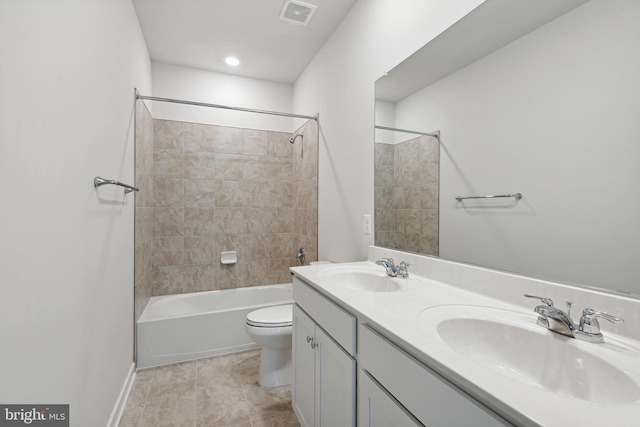 full bathroom featuring vanity, toilet, tile patterned floors, and tiled shower / bath combo