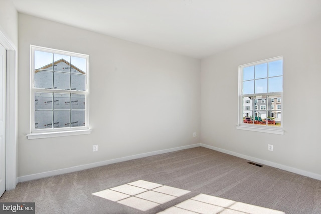 spare room with light carpet