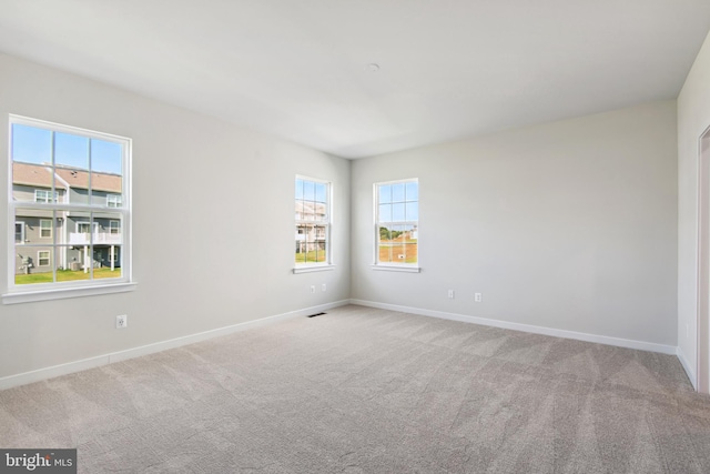 unfurnished room with light carpet