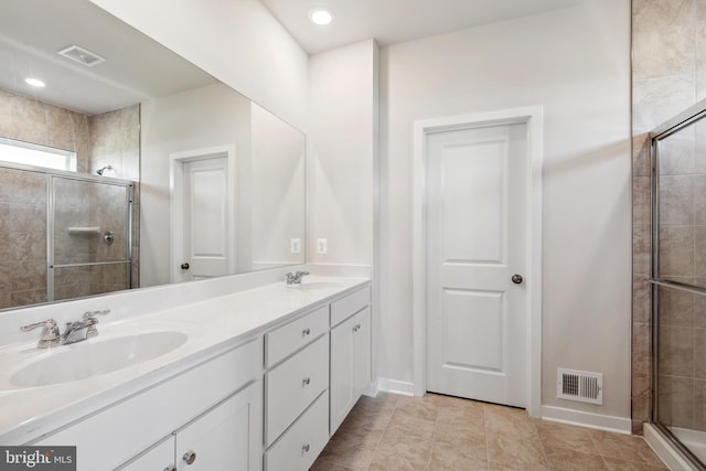 bathroom featuring vanity, tile patterned floors, and walk in shower