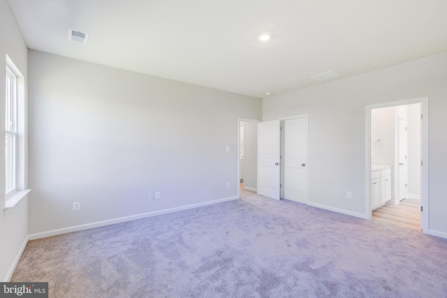 unfurnished room with light carpet