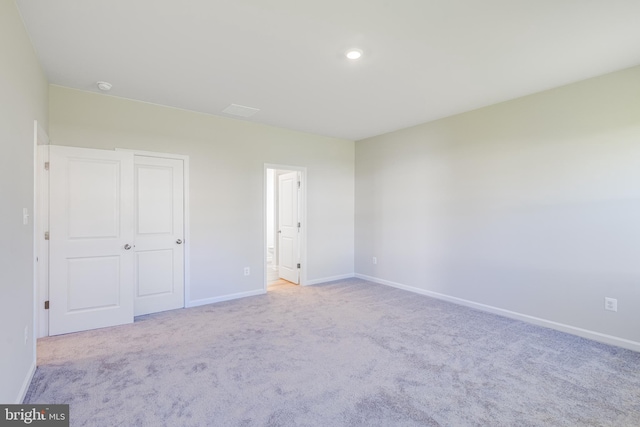 unfurnished bedroom featuring light colored carpet