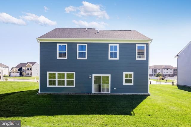 rear view of property with a lawn