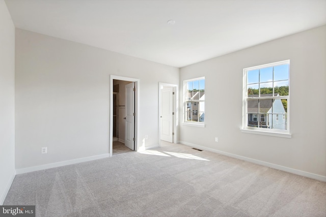 unfurnished bedroom featuring light carpet