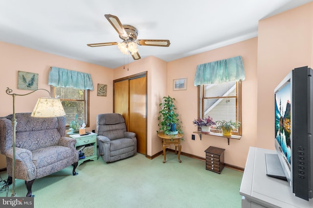 sitting room featuring carpet and ceiling fan